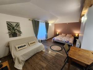 a bedroom with a bed and a table in a room at Studio du moulin de Montizeau in Saint-Maigrin