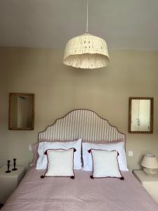 a bedroom with a large bed with two pillows at El Corral de Tía Gloria in Pepino