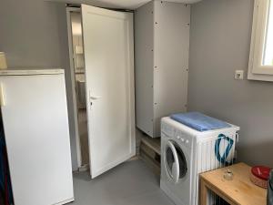 a laundry room with a washing machine and a washer at Maisonnette Bassin d'Arcachon in Mios