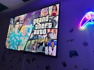 a television screen with a poster of grand theft algebra at Le game clem in Saint-Étienne