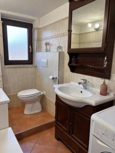 a bathroom with a sink and a toilet and a mirror at Casa PerlAmbra Abruzzo in Casagreca +61 photos