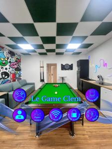 a living room with a pool table with frisbees on it at Le game clem in Saint-Étienne