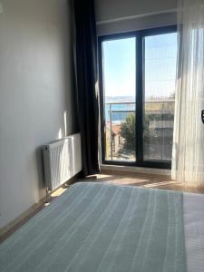 a room with a large window with a view at Sevez Homes in Gelibolu