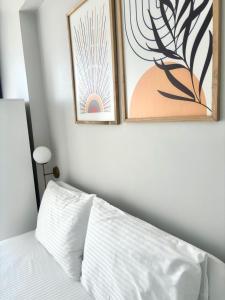 a bedroom with two framed pictures above a bed at Sevez Homes in Gelibolu