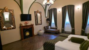 a bedroom with a bed and a fireplace and mirrors at VICTORIAN HOUSE in Sibiu