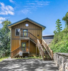 a house with a staircase leading up to it at Distiller's Den in Gatlinburg