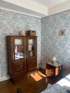 a living room with a book shelf and a table at Chambres d hôtes H in Lavelanet