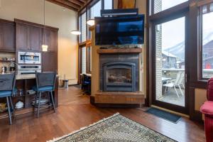 ein Wohnzimmer mit Kamin und Flachbildfernseher in der Unterkunft Luxurious 901 Condos by Fernie Central Reservations in Fernie + 176 Fotos