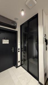 a hallway with two glass doors in a building at Преміальні апартаменти на березі озера Молодості in Bukovel