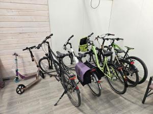 a group of bikes parked next to a wall at Domki BAMBINO in Sarbinowo
