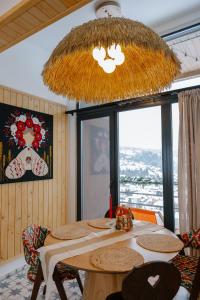 a dining room with a table and a chandelier at Vershok villa in Slavske