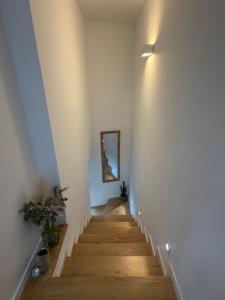 a stairway with a mirror on a white wall at Quinta do Passal - Country house in Parada de Ester