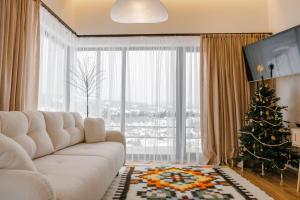 a living room with a white couch and a christmas tree at Vershok villa in Slavske