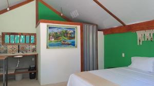 a bedroom with a bed and a painting on the wall at Casa AllíS in Cóbano