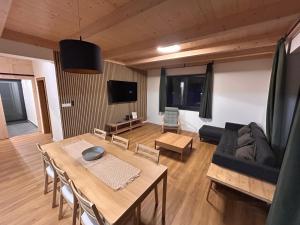 a living room with a table and a couch at Apartmánový dom DK Ateliér in Dolný Kubín