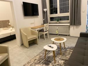 a living room with a couch and a tv at Ferienwohnung in Solingen Innenstadt in Solingen