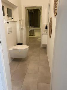 a bathroom with a toilet and a sink at Ferienwohnung in Solingen Innenstadt in Solingen