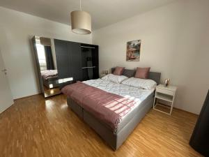 a bedroom with a large bed and a mirror at Faraway Homes Studio Krieglach #7 in Sommer