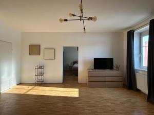 a living room with a television on a dresser and a window at Faraway Homes Studio Krieglach #7 in Sommer