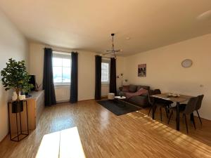 a living room with a couch and a table at Faraway Homes Studio Krieglach #7 in Sommer