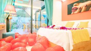 a room with a bed and a table with heart balloons at Villa Adalya in Kaş