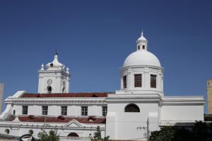 a white building with a clock tower on top of it at Casa Verde Boutique Hotel in Santa Marta +65 photos