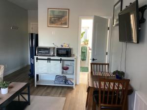 a kitchen with a counter with a microwave and a table at The Cozy Nook in Grand Forks +12 photos