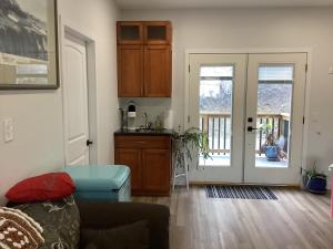a living room with a couch and a kitchen at The Cozy Nook in Grand Forks