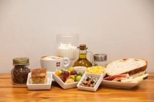 a table with a plate of food and a sandwich at ABCyou Bed&Breakfast in Valencia