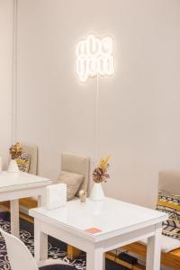 a room with two tables and a sign that reads go you at ABCyou Bed&Breakfast in Valencia