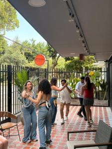 a group of people standing outside of a building at Bohemia Boutique Hostel in Cali