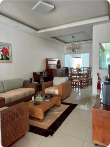 a living room with a couch and a table at Pousada da Nona in Barretos
