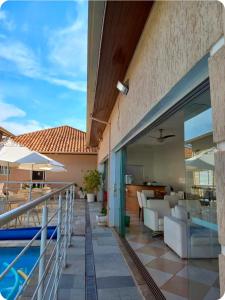 a balcony with a swimming pool and a house at Pousada da Nona in Barretos