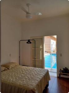 a bedroom with a bed and a large window at Pousada da Nona in Barretos +17 photos