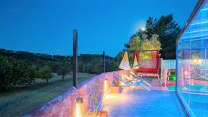 a house with a swimming pool and a table and chairs at Villa Adalya in Kaş