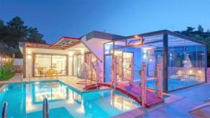 a house with a swimming pool and a house at Villa Adalya in Kaş