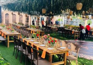 a group of tables and chairs with flowers on them at Cromer Apartment Hotel in Accra