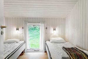 two beds in a white room with a window at 931-Thisted-Pinbak-24 in Torsted +23 photos