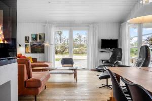 a living room with a couch and chairs and a table at 931-Thisted-Pinbak-24 in Torsted