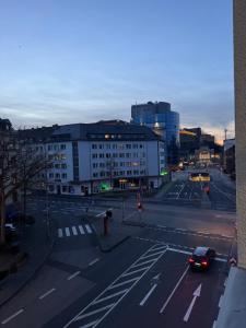a view of a city street with a car on the road at City Rooms Koblenz Hbf in Koblenz