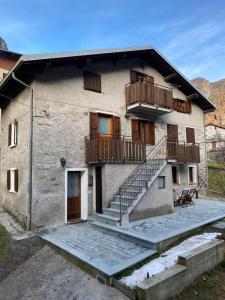 a building with a balcony and stairs on it at Villa Vetto in Lanzada