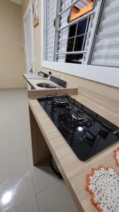 a kitchen with a stove and a sink at Cantinho do sossego in Capão da Canoa