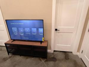 a flat screen tv sitting on a stand next to a door at Special Deal on Booking Unit 664 in Paris
