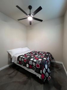 a bedroom with a bed with a ceiling fan at Special Deal on Booking Unit 664 in Paris