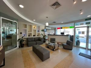 a living room with a couch and a table at Angeles Suites & Hotel in Veracruz