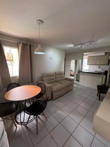 a living room with a couch and a table at Apartamento confortável in São Luís