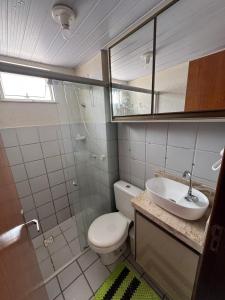 a bathroom with a toilet and a sink at Apartamento confortável in São Luís