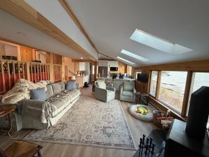a living room with a couch and a rug at Barnacle - quiet family Maine waterfront getaway in Orrs Island