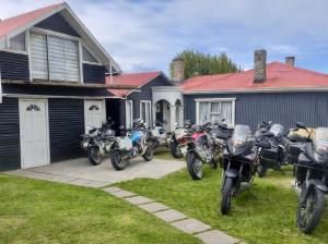 a group of motorcycles parked in front of a house at Barso Home Puerto Natales in Puerto Natales +1 photo