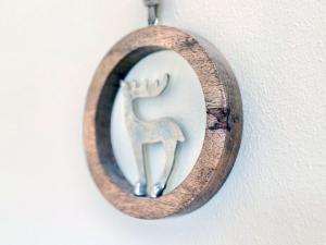a wooden christmas ornament with a reindeer on a wall at Sonnenhof Seeg 04 in Seeg